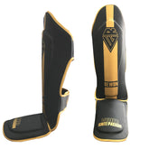 Rewon classic black and gold shin guards for kickboxing with padded protection and adjustable straps, ideal for boxing and MMA training.